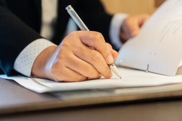 Asian Business people Manager checking and signing applicant filling documents reports papers company application form or registering claim on desk office. Document Report and business busy Concept