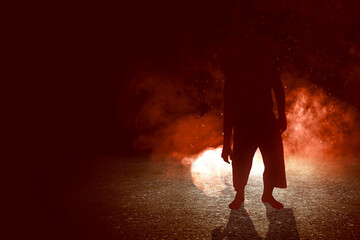 Silhouette of zombie walking with an explosion