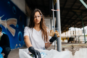 Fototapeta na wymiar Young woman sorting garbage. Concept of recycling. Zero waste