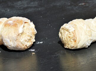 
two custard cakes lies on a black wooden table