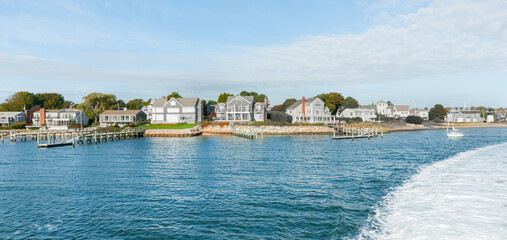 Charactistic style Cape Cod architecture along waters edge.