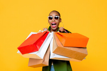 Beautiful fashionable African American woman with colorful shopping bags in surprised sale concept...