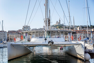 Large sailing catamaran in a marina in Marseille. Tourism and travel. Sunny day. Beautiful...