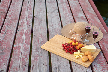 Two glasses of red wine, served outdoor with fruits