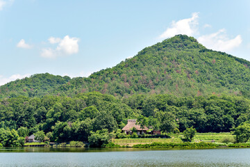 A traditional thatched roof Japanese house  preserved at a public park in Sanda, Hyogo, Japan in early summer