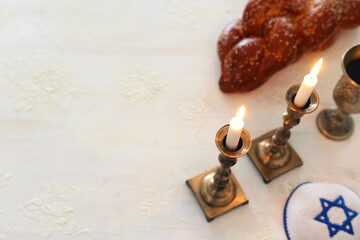 shabbat image. challah bread, shabbat wine and candles. Top view