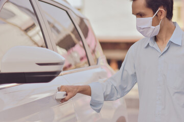 Asian man use face mask at car parking on street new normal social distancing concept