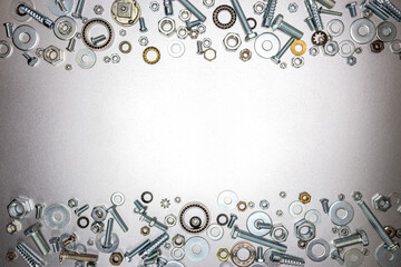 frame design. chrome-plated bolts and nuts on gray metal surface with copy space