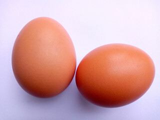Chicken eggs paired on a white background