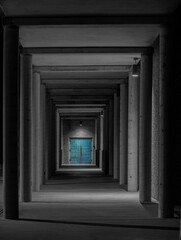 Greek-style dark corridor to turquoise doors
