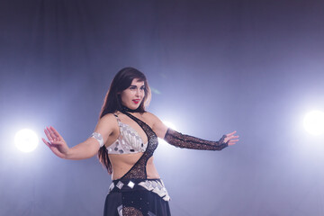 Spirituality dance. Beautiful sexy woman with luxury glossy eastern make-up dancing tribal fusion. Belly dance.