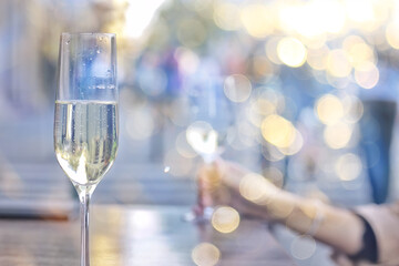 glasses of toast chin chin, hands with glasses of white wine in a street cafe