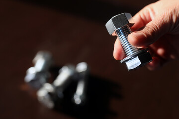 View of the bolt, nuts and washer. A fastener (US English) or fastening (UK English) is a hardware...