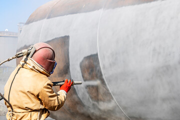 Close up view of sandblasting before coating. Abrasive blasting, more commonly known as sandblasting, is the operation of forcibly propelling a stream of abrasive material against a surface. - obrazy, fototapety, plakaty