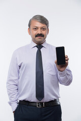 Happy businessman showing mobile phone