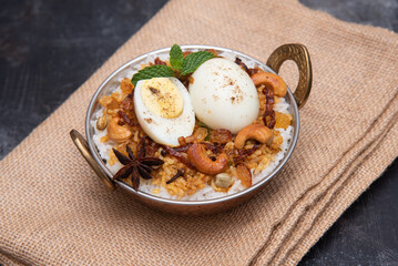 Egg Biryani or Indian anda rice - Basmati rice cooked with masala roasted eggs and spices and served with yogurt popular rice food in India