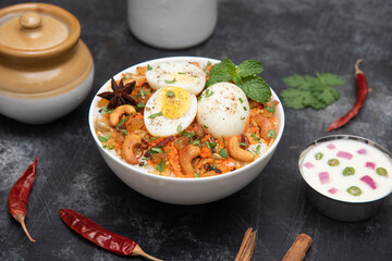 Egg Biryani or Indian anda rice - Basmati rice cooked with masala roasted eggs and spices and served with yogurt popular rice food in India