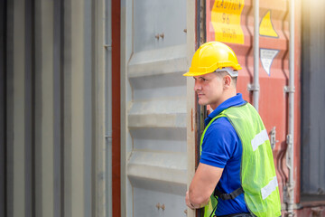 Foreman worker in hard hat and safety vest checking containers box from cargo