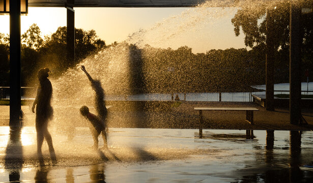 Children playing in a playground water jets in Gladstone, Queensland