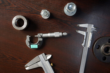 View of the ball micrometer gauge, caliper micrometer gauges and steel materials on the table.
