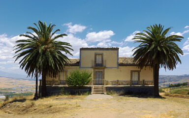 Fototapeta na wymiar Traditional Rural House With Palm Trees Of Sicily Architecture