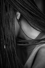 Details of body black and white portrait of beautiful girl, fashion and art, afro pigtails, pigtails, dreadlocks
