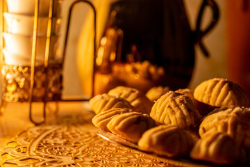 Eid sweets served with head scarf as background