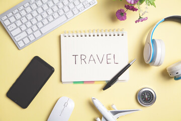 Travel text on notepad with a other objects.