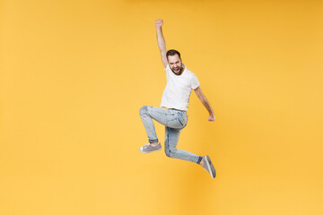 Side view of happy young bearded man guy in white casual t-shirt posing isolated on yellow...