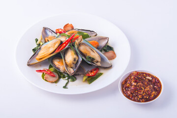Steamed mussels with herb in the white dish.