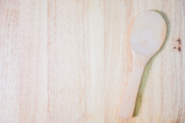 Wooden spoon on rustic wood background. View from above