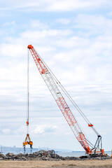 View of the big crawler crane is working in the consruction field.