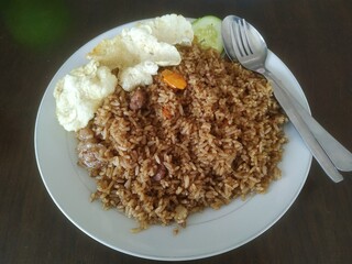 Goat fried rice served on the table with fresh tea