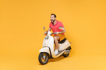 Surprised young bearded man guy in casual summer clothes driving moped isolated on yellow wall...