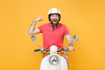 Shocked young bearded man guy in casual summer clothes driving moped isolated on yellow background...