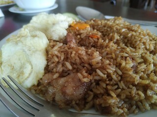 Goat fried rice served on the table with fresh tea