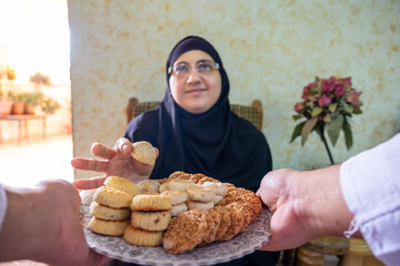 Muslim woman picking some homemade sweets