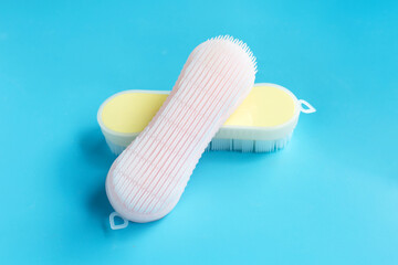 Brush for cleaning clothes on blue background.
