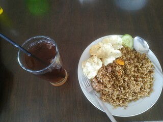 Goat fried rice served on the table with fresh tea