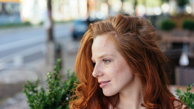 Attractive redhead woman with a faraway expression