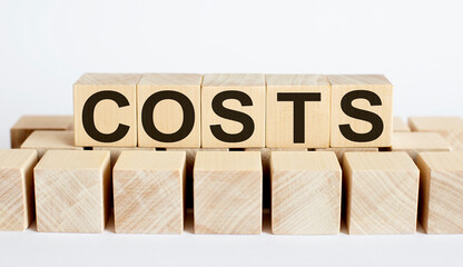 COSTS word from wooden blocks on desk, search engine optimization concept