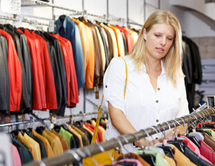 Woman choosing leather jacket