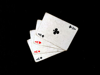 Obraz premium Set of four aces playing cards suits. Winning poker hand isolated on black background