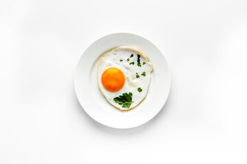 Fried eggs on plate - white kitchen table top-down