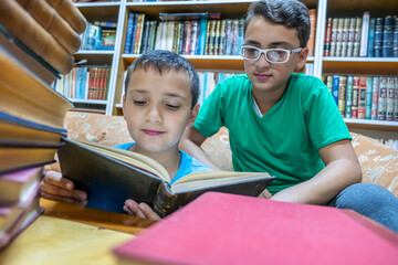 Muslim arabic boy reading book in library