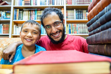 Muslim arabic boy reading book in library