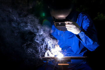 Industry worker mechanic welding iron at industrial factory.