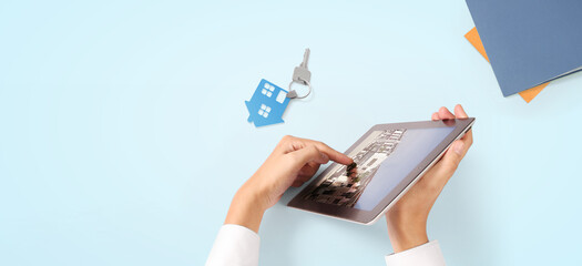 Man with tablet in his hands chooses house for his family, and broker giving property key