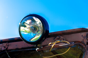 Old headlight with a crack. inscription on glass headlights: "made in the USSR"
