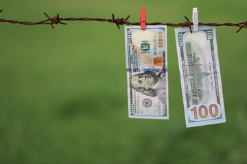 Money Laundering. Money Laundering US Dollars Hung Out To Dry. 100 Dollar Bills Hanging On Rusty...